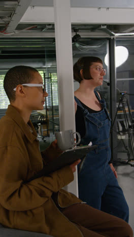 Vertical-Video-Of-Frustrated-Female-Film-Director-Watching-Performance-Of-Actors-On-Monitor-Shooting-Movie-In-Studio-Shot-In-Real-Time